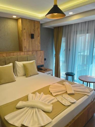 a bedroom with a large bed with two towels on it at Yellow Bull Istanbul hotel in Istanbul