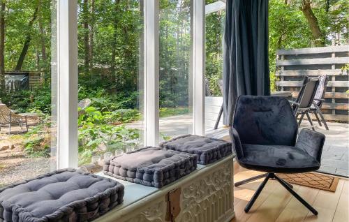 a room with two chairs and a chair and a window at 3 Bedroom Lovely Home In Holten in Holten