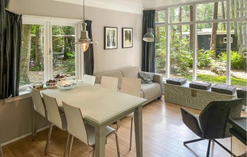 a kitchen and living room with a table and chairs at 3 Bedroom Lovely Home In Holten in Holten