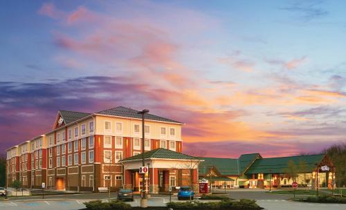 a large building with a sunset in the background at Oxford Casino Hotel in Oxford