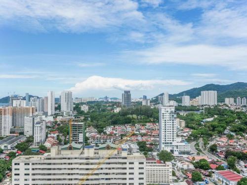 a cityscape of a city with tall buildings at Comfort 3 Bedroom Urban Suite by Uptrend Home Management in Jelutong