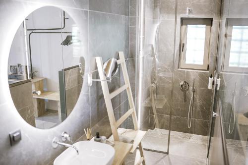 a bathroom with a mirror and a sink and a shower at Muses in Kourouta