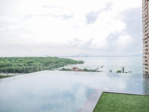 a view of a large body of water between two buildings at Comfort 3 Bedroom Urban Suite by Uptrend Home Management in Jelutong