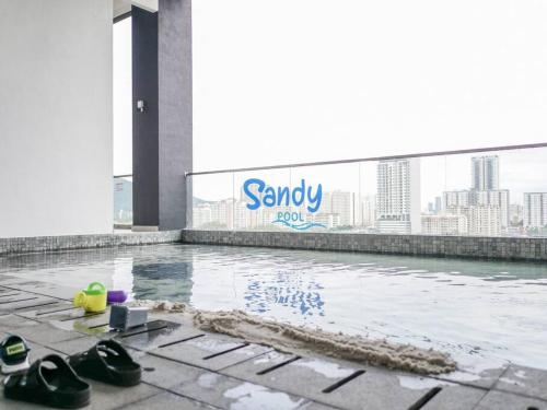 a pair of shoes sitting on the floor of a building at Comfort 3 Bedroom Urban Suite by Uptrend Home Management in Jelutong