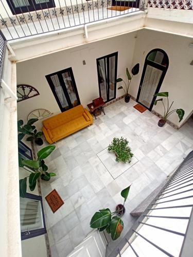 an overhead view of a living room with plants at Apartamentos La Higuera by VGH in Jerez de la Frontera