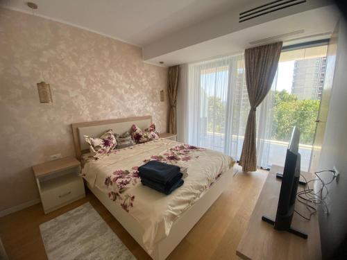 a bedroom with a bed with a bag on it at Apartament Alex S 405 Vogh Olimp in Olimp