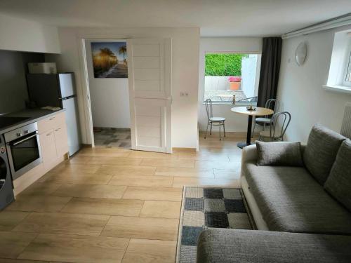 a living room with a couch and a kitchen and a table at Elpo House in Neveronys