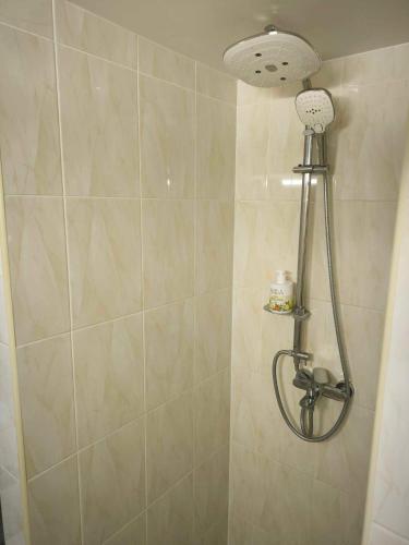 a shower with a shower head in a bathroom at Elpo House in Neveronys