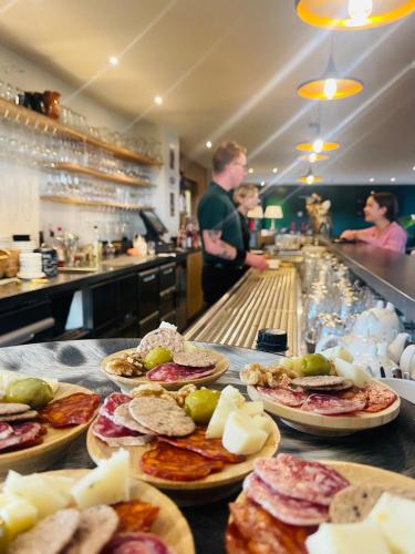 a buffet line with plates of food in a restaurant at Equus B&B in Bredene