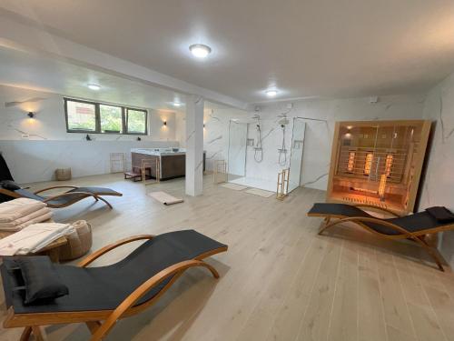 a large room with chairs and a shower in it at REY Chalet in Vatra Dornei