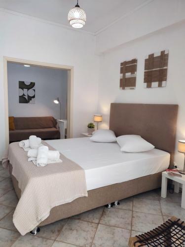 a bedroom with a large bed with towels on it at Feidiou 1 vol II in Egina