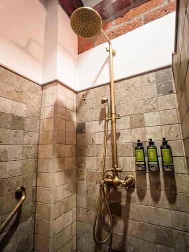 a shower with three bottles on the wall at Casa Linaje Hotel Boutique by HMC -Cauca Viejo- Mayores de 10 años in Jericó