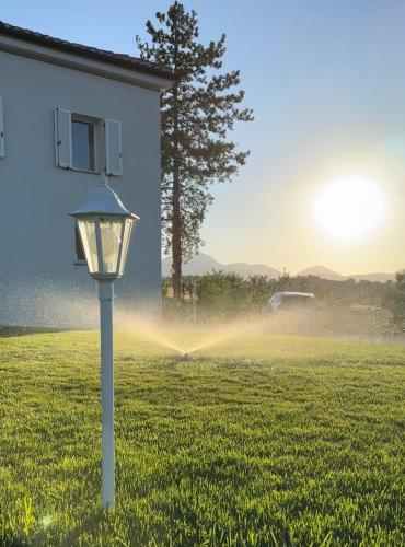 a street light in a field with a house at La Villa Suite 2 in Fabriano
