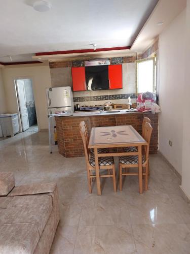 a kitchen and dining room with a table and chairs at شاليه سوبر لوكس in El Alamein