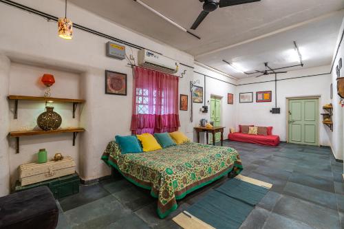 a bedroom with a bed in a room at StayVista's Suman Vatika - Pench - Outdoor Pool, Rainshower & Terrace in Khawāsa