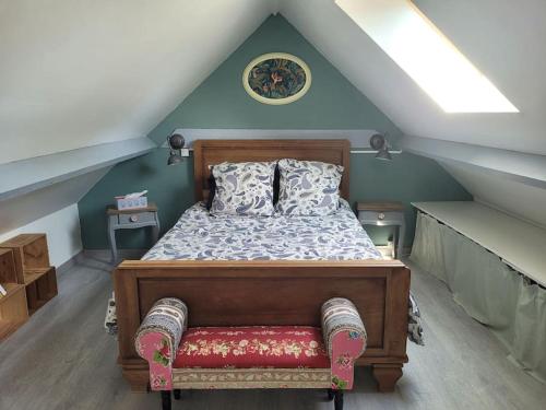a bedroom with a bed in a attic at Maison à la campagne in Haut-Hameau