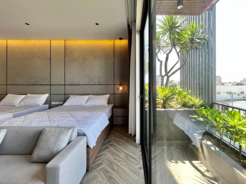 Een bed of bedden in een kamer bij T E U Hotel & Apartment Da Nang