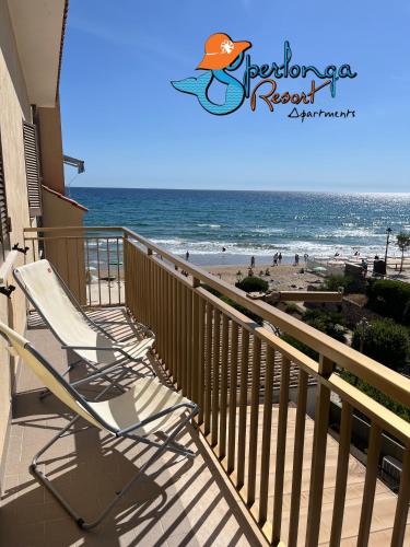 two chairs sitting on a balcony overlooking the beach at Casa Marea Sperlongaresort apartment in Sperlonga