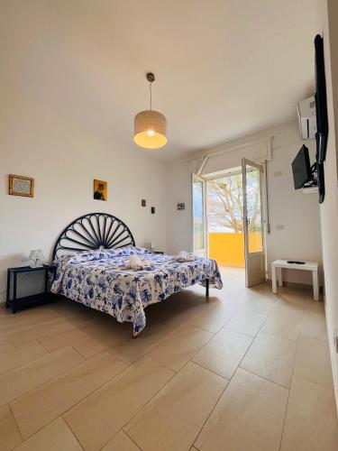 ピッツォにあるGiardini Segretiのベッドと大きな窓のある寝室