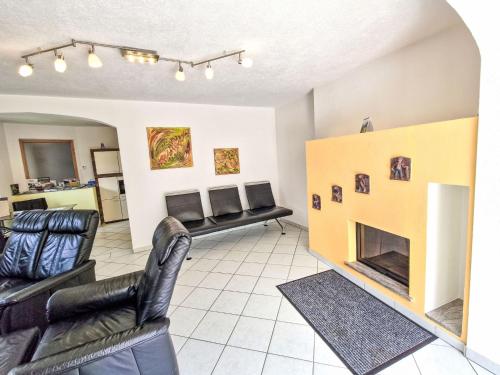 a living room with two chairs and a fireplace at Holiday Home Heidi by Interhome in Rieden