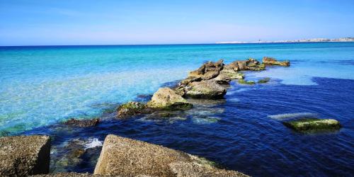 a group of rocks in the water near the ocean at GIORGIa HOUSE in Matino