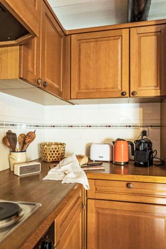 a kitchen with wooden cabinets and a counter top at Holiday Home La Formighera by Interhome in Gerra Verzasca