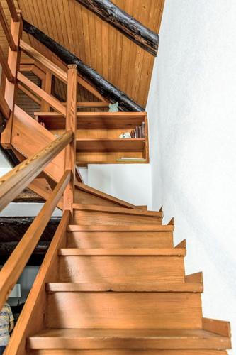 a wooden staircase in a house with wooden railing at Holiday Home La Formighera by Interhome in Gerra Verzasca