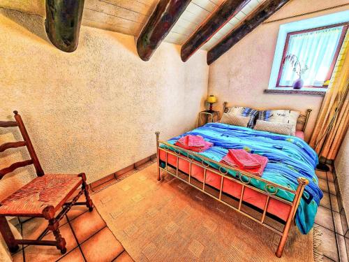 a bedroom with a bed and a chair in a room at Holiday Home La Formighera by Interhome in Gerra Verzasca