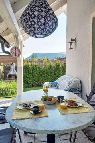a table with two plates of food on top of it at Holiday Home Seehaus Blue Faak by Interhome in Faak am See