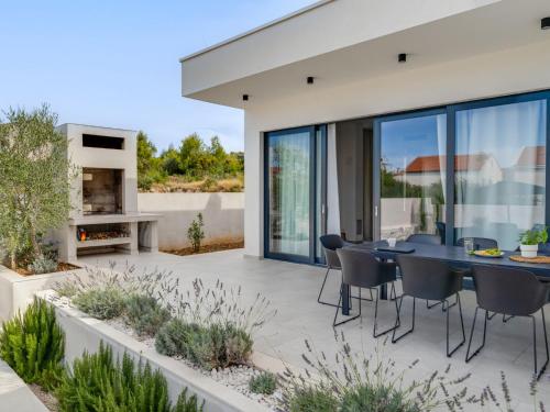a patio with a dining table and chairs on it at Villa Inizio by Interhome in Brodarica
