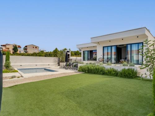 a house with a lawn in front of it at Villa Inizio by Interhome in Brodarica