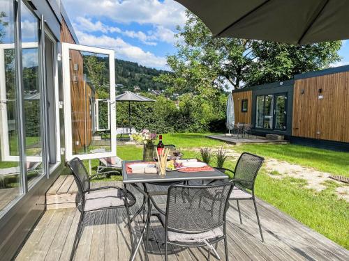 a patio with a table and chairs on a deck at Holiday Home Tiny Haus Sonnenplatz by Interhome in Riedenburg