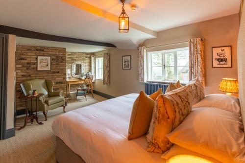 a bedroom with a bed and a desk in a room at The Fitzherbert Farmhouse in Swynnerton