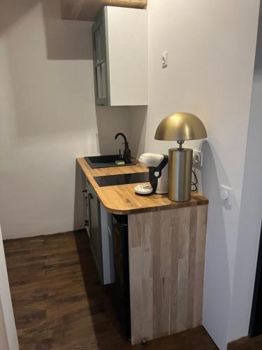 a kitchen with a counter with a lamp on it at Château d'Aynac in Aynac