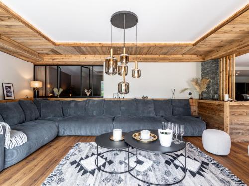 a living room with a blue couch and a table at Apartment Le Canvolan-1 by Interhome in Tignes