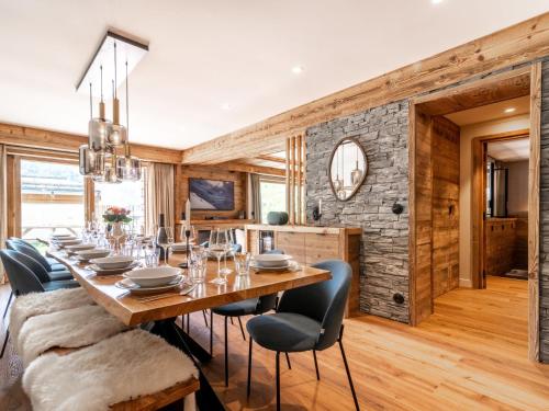 a dining room with a long wooden table and chairs at Apartment Le Canvolan by Interhome in Tignes