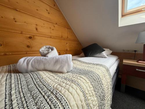 a bed with two white towels on top of it at Hotel 365 in Kielce