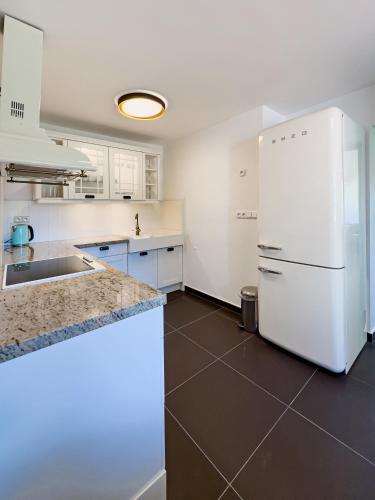 a kitchen with white appliances and a white refrigerator at Bezdrevská Bašta in České Budějovice