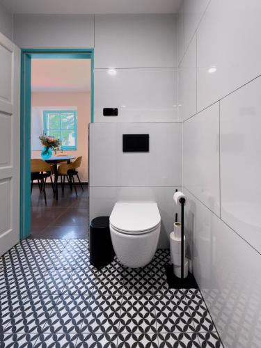 a bathroom with a white toilet in a room at Bezdrevská Bašta in České Budějovice