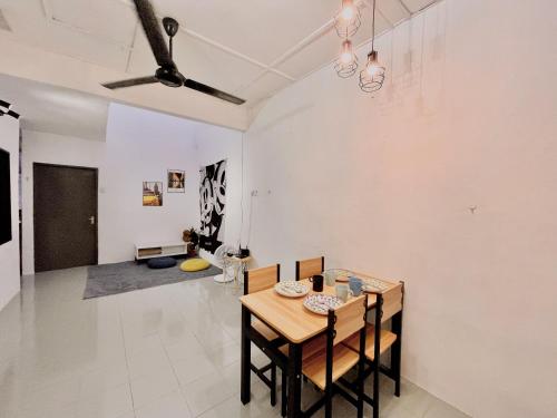 a dining room with a table and chairs at Heritage Cozy Entire 3 Bedroom House At Kijang Alma Bukit Mertajam in Bukit Mertajam