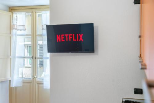 a netflix sign on a wall next to a window at Residenza Duomo in Alba