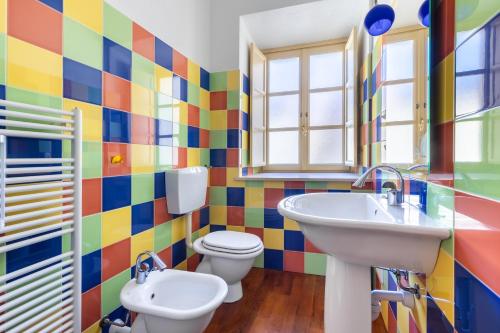 a colorful bathroom with a sink and a toilet at Residenza Duomo in Alba