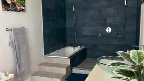 a bathroom with a tub and a sink and a bath tub at ZenBreak Hope Winds in Christ Church