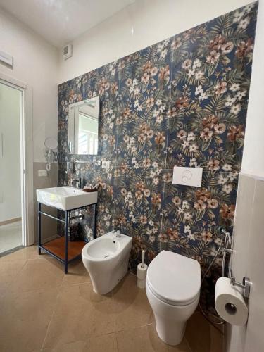 a bathroom with a toilet and a sink at BURMARIA APARTMENT and ROOM with garden and jacuzzi in Tropea