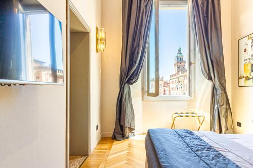 a bedroom with a bed and a large window at Casa Galatea in Canton de Fiori in Bologna