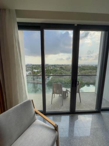a living room with sliding glass doors and a couch at Hotel Mio Riviera Nayarit - Adults Only in Nuevo Vallarta 