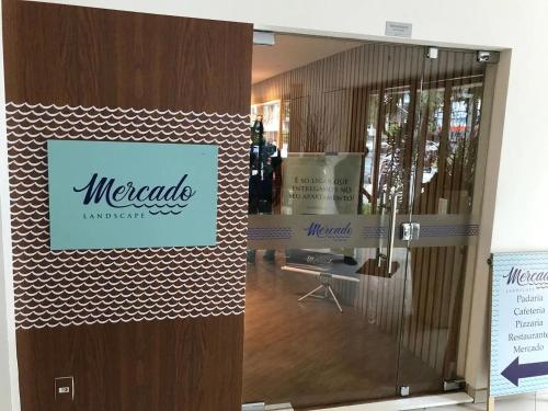 a door in a store with a sign on it at Landscape Beira Mar - Lindo, Luxo, Frente mar in Fortaleza