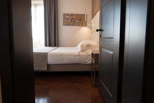 a small bedroom with a bed and a window at Le Cappuccinelle Suites&SPA in Perugia