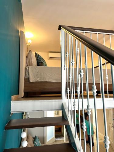 a staircase with a bunk bed in a house at Ta' Dun Martin and taz-Zija Bed and Breakfast in Nadur