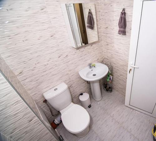 a bathroom with a toilet and a sink at Benny's flat in Stara Zagora
